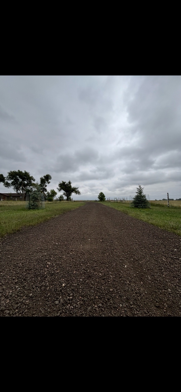 Close-up of compacted gravel driveway surface showing quality materials