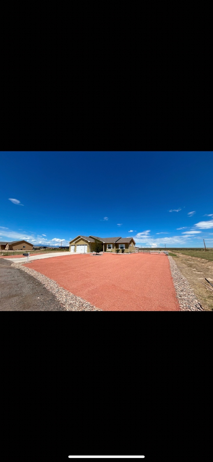 Decorative red rock driveway installation in Colorado